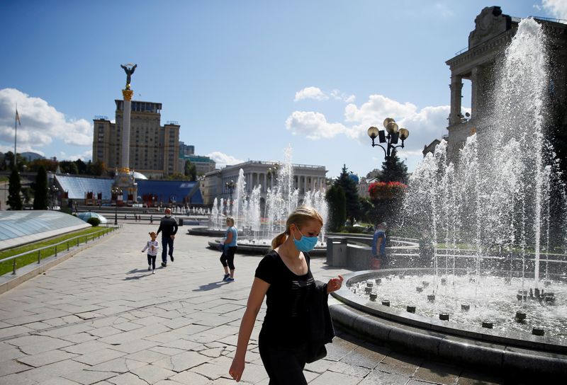 Woman wearing a protective face mask walks in central Kiev