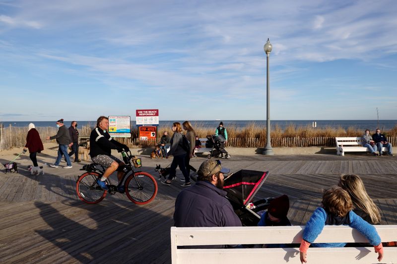 People try to keep a social distance on the boardwalk
