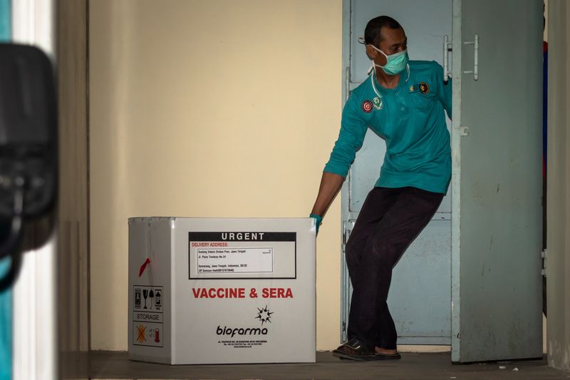 An officer moves a box of Sinovac’s vaccine for coronavirus