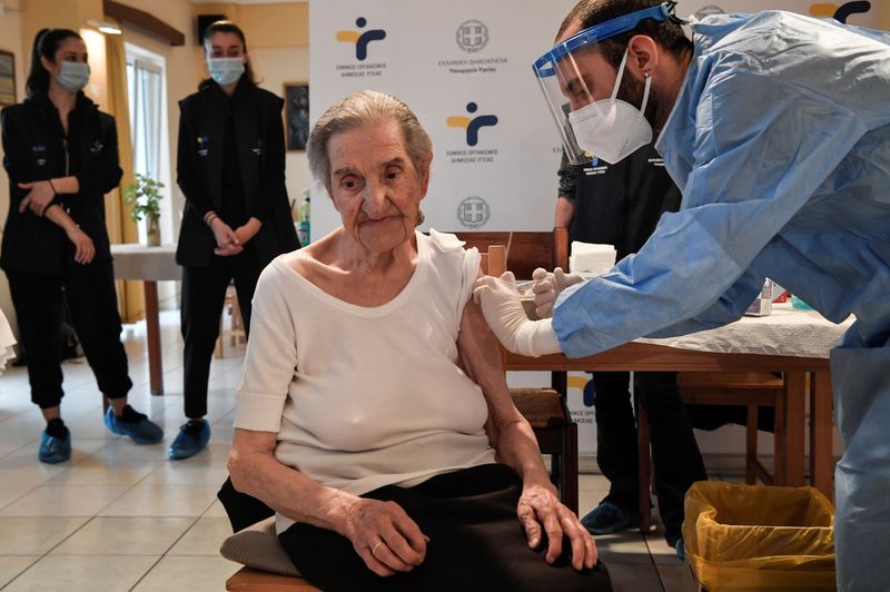 An elderly woman receives a vaccine against the coronavirus disease