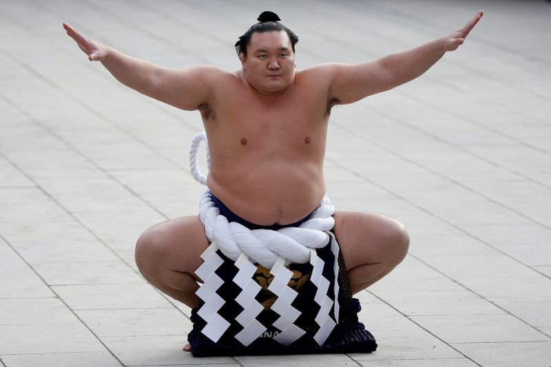FILE PHOTO – Mongolian-born grand sumo champion yokozuna Hakuho performs