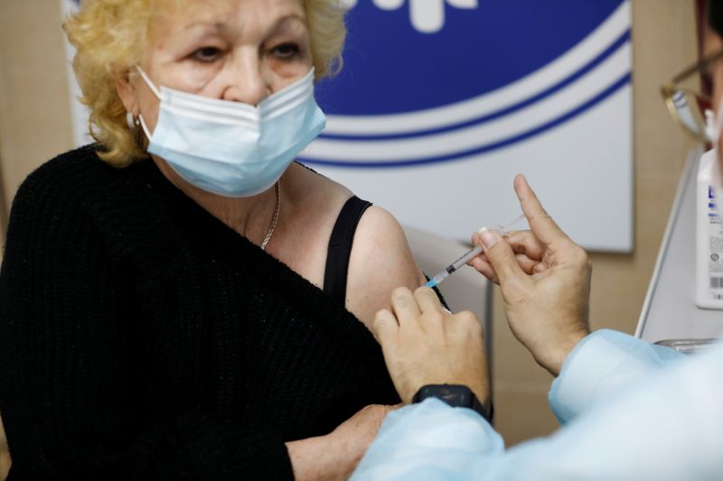 A woman receives a vaccination against the coronavirus disease (COVID-19)
