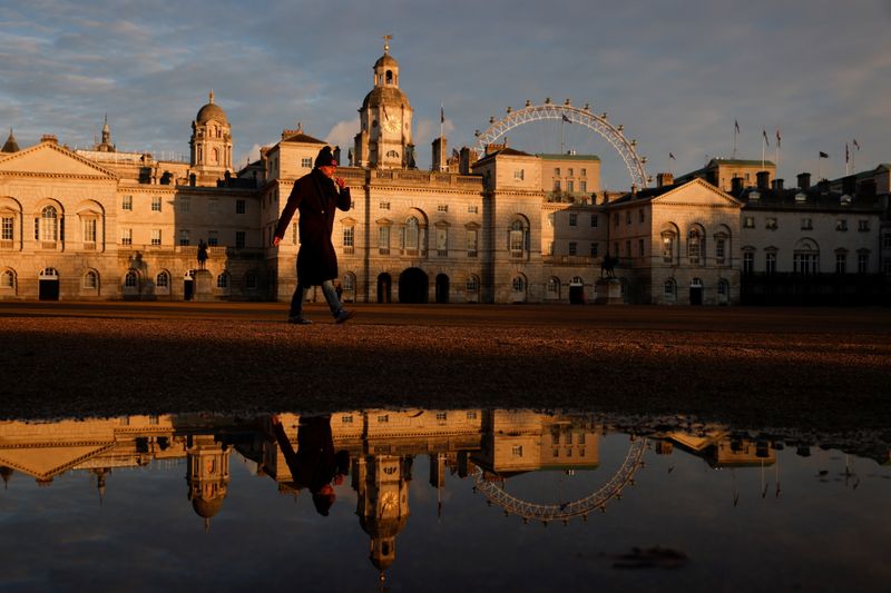 A man walks across Horse Guards Parade in the late