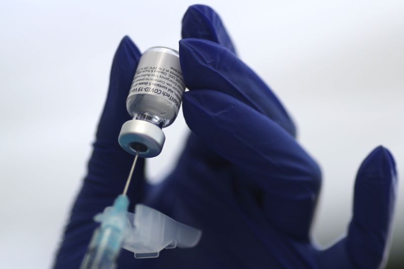 A healthcare worker prepares a Pfizer coronavirus disease (COVID-19) vaccination