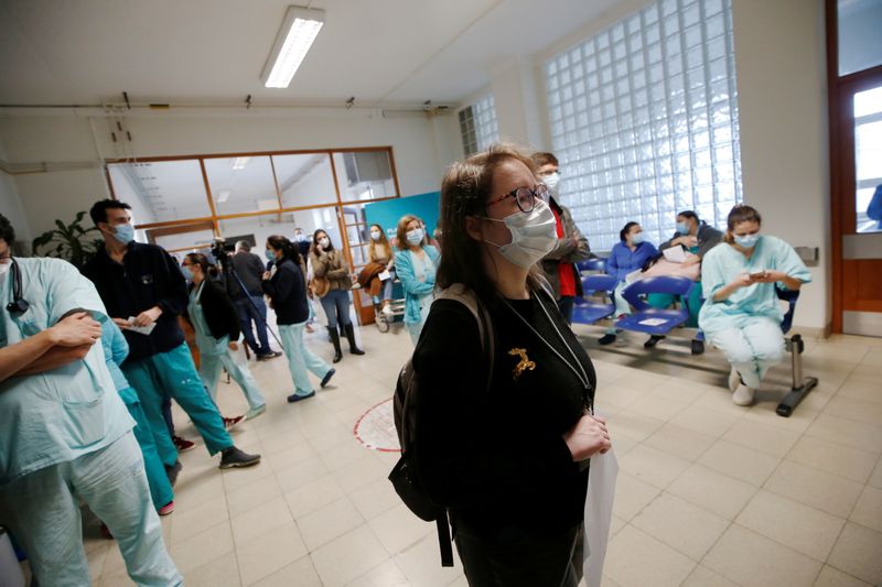 Medical workers wait to receive the Pfizer-BioNTech coronavirus disease (COVID-19)