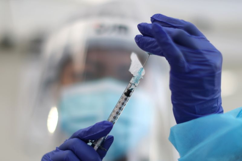 A healthcare worker prepares a Pfizer coronavirus disease (COVID-19) vaccination