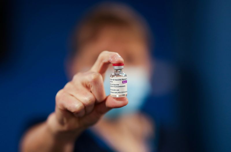 FILE PHOTO: A healthcare worker holds a vial of the