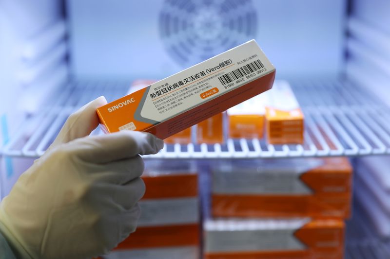 Medical worker takes a box of Sinovac’s vaccine against the