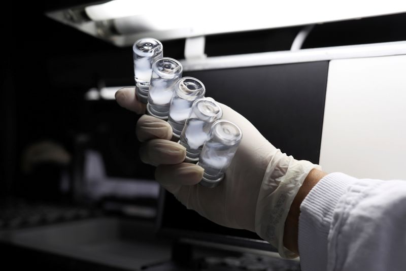 FILE PHOTO: An employee inspects vials of Sinovac’s CoronaVac COVID-19
