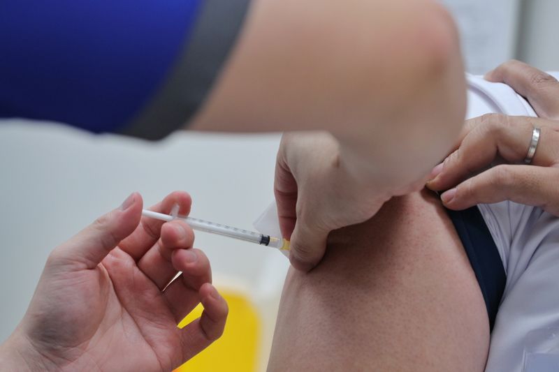 A healthcare worker receives the coronavirus disease (COVID-19) vaccine at