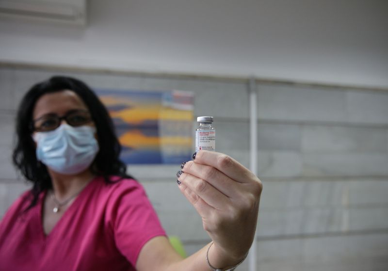 Medical staff member shows the Moderna coronavirus disease vaccine at