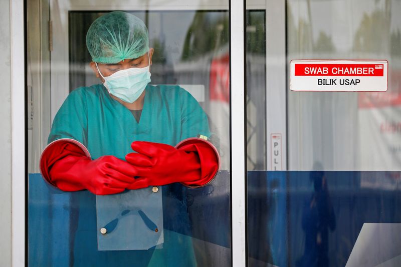 FILE PHOTO: A medical worker stands inside a swab chamber