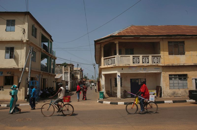 FILE PHOTO: People move in the street in Banjul