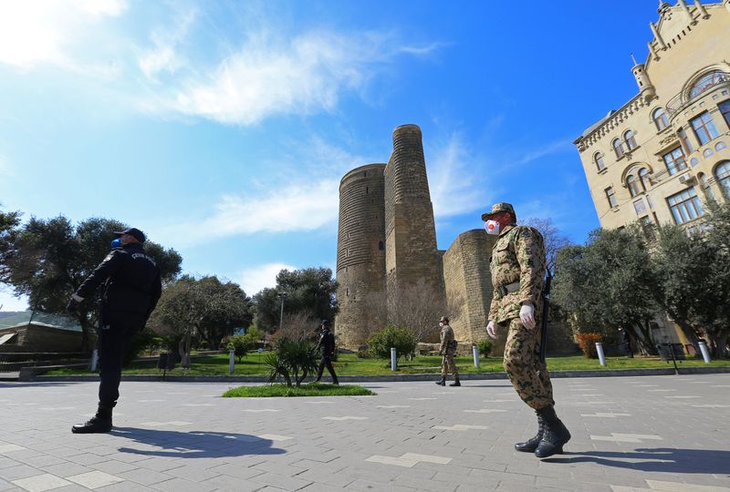 Azeri servicemen and law enforcement officers patrol the territory in