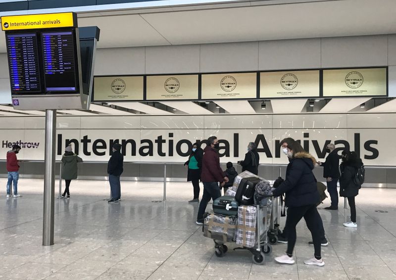 Passengers from international flights arrive at Heathrow Airport in London
