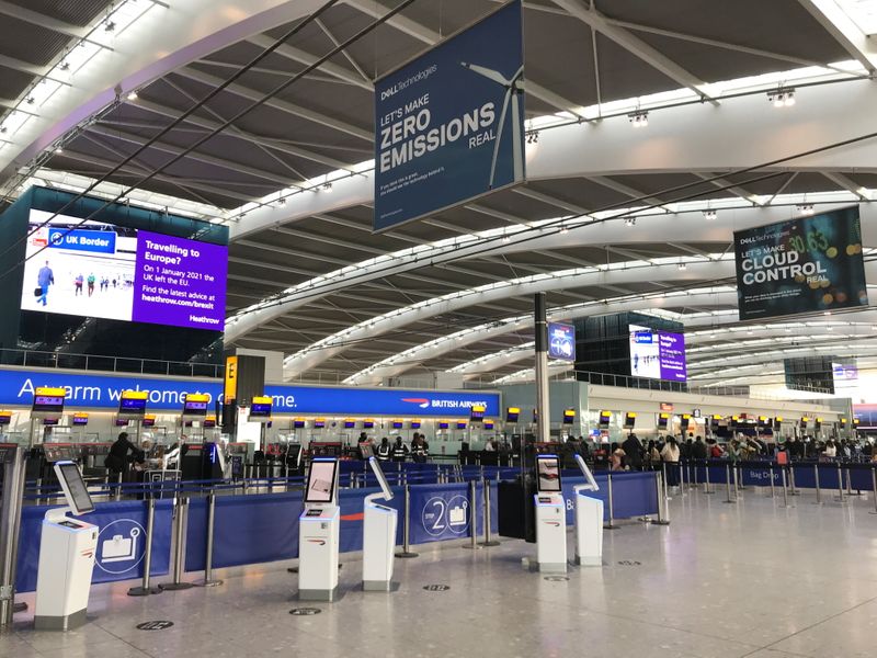 Passengers at BA check-in desks at Heathrow Airport in London