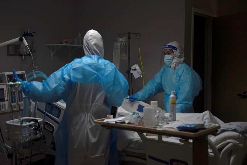 Healthcare personnel work inside a COVID-19 unit in Houston