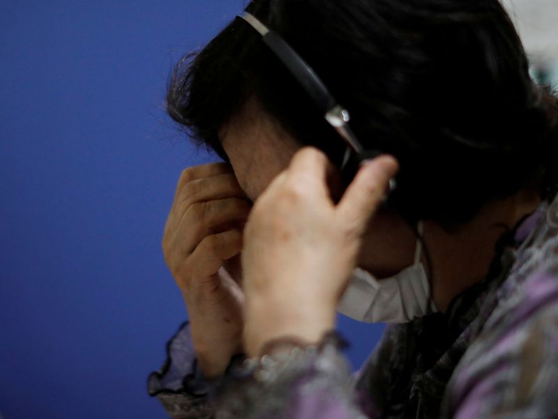 FILE PHOTO: A volunteer responds an incoming call at the