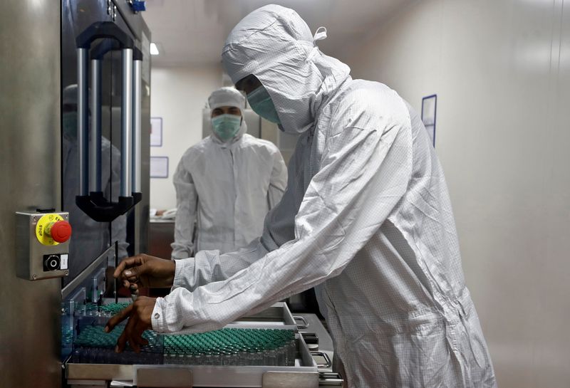 FILE PHOTO: An employee in personal protective equipment (PPE) removes