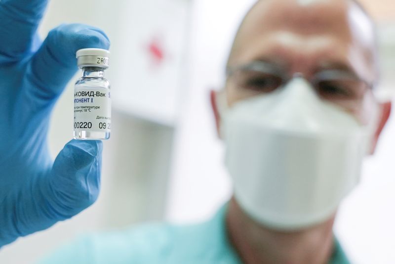 FILE PHOTO: A medical worker holds a vial of the