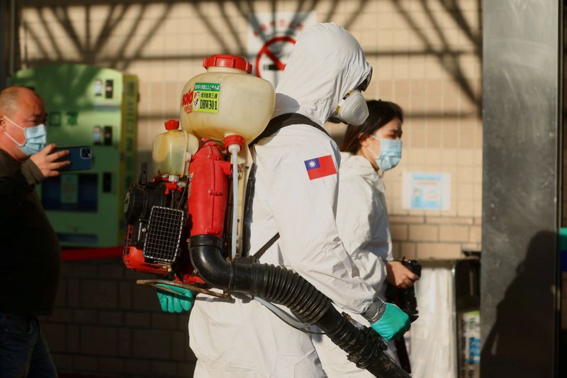 FILE PHOTO: Soldiers prepare to spray disinfectant outside the Taoyuan