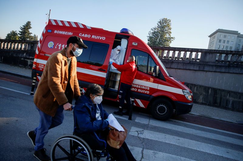 FILE PHOTO: An ambulance carrying a COVID-19 patient is seen
