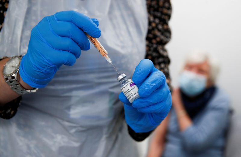FILE PHOTO: A health worker fills a syringe with a