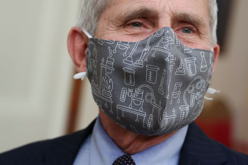 Fauci wears a lab equipment-themed mask as he arrives for