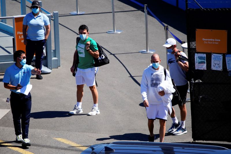 Quarantined Australian Open tennis players leave a restricted training area