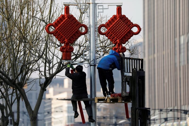 Workers set up street lights ahead of the Chinese Lunar