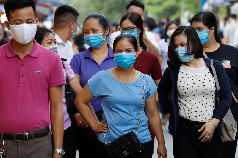 FILE PHOTO: Pilgrims wear protective masks as they go to
