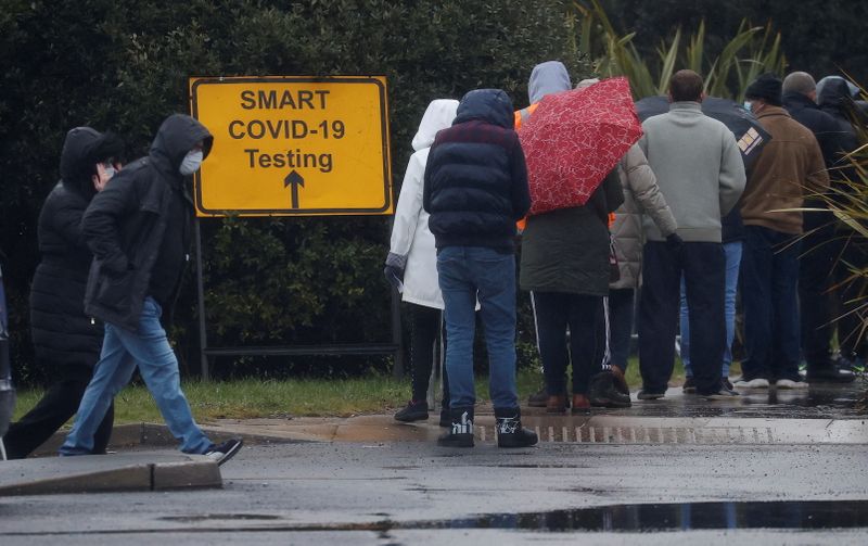 People queue at a testing centre amid the outbreak of