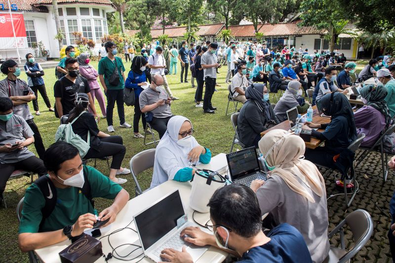 Indonesian healthcare workers are seen during verification and health screening