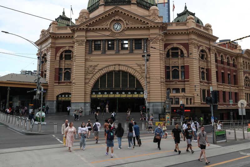People enter and exit Flinders Street Station in Melbourne