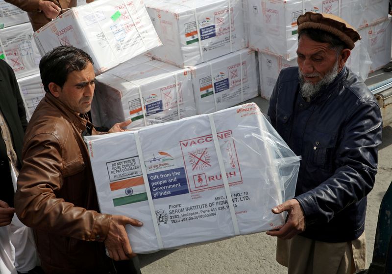FILE PHOTO: Workers from Afghan health ministry unload boxes containing