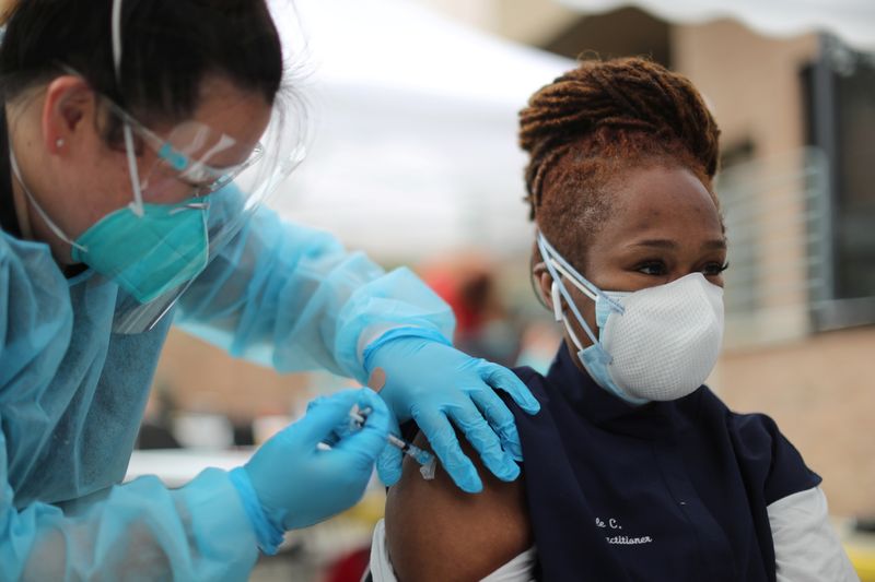 FILE PHOTO: Nurse practitioner Nicole Monk, 44, receives a coronavirus