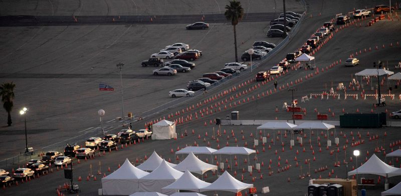 FILE PHOTO: Vehicles line up at Dodger Stadium COVID-19 vaccination