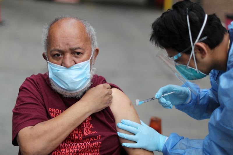 Enrique Ramezi, 56, receives a coronavirus disease (COVID-19) vaccination at
