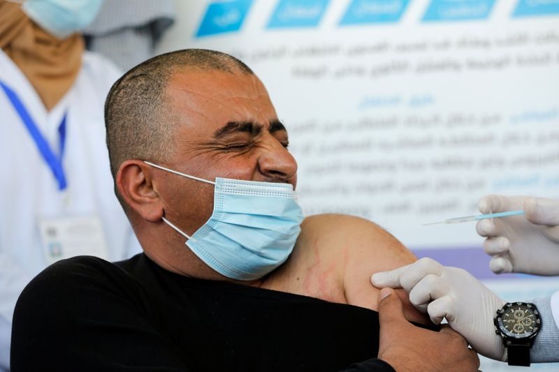 FILE PHOTO:  Palestinian health workers are vaccinated against COVID-19