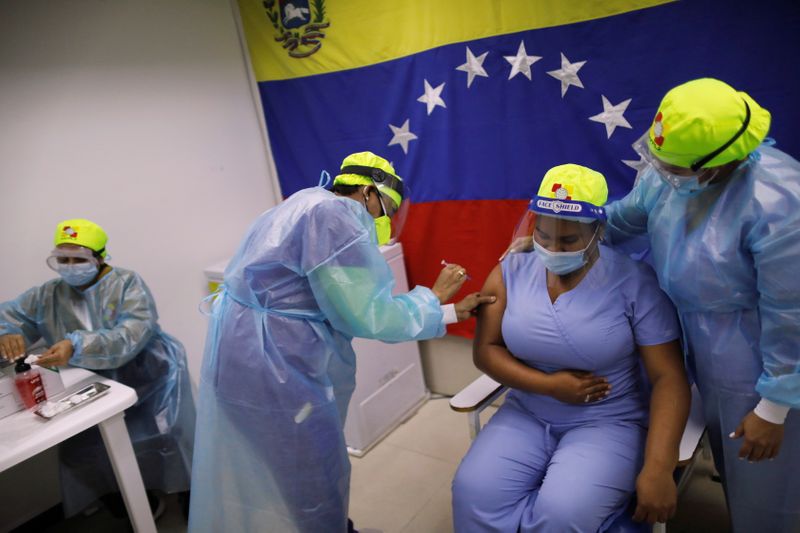 Venezuelan health workers vaccinate colleagues with Russia’s Sputnik V vaccine