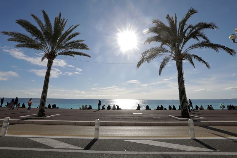 FILE PHOTO: People take their lunch on the Promenade des
