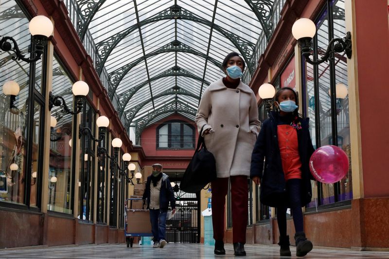 FILE PHOTO: People wearing protective face masks in Paris