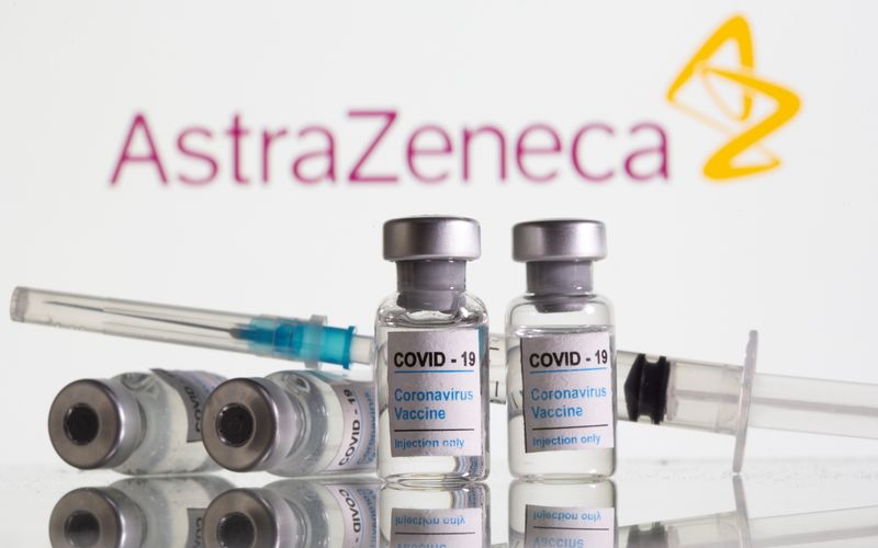 Vials labelled “COVID-19 Coronavirus Vaccine” and sryinge are seen in