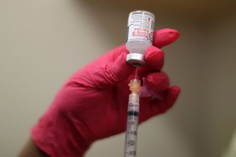 A nurse draws a Moderna coronavirus disease (COVID-19) vaccine, at