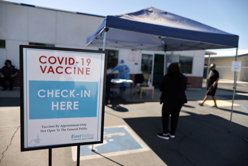 FILE PHOTO: People arrive for coronavirus disease (COVID-19) vaccinations, at