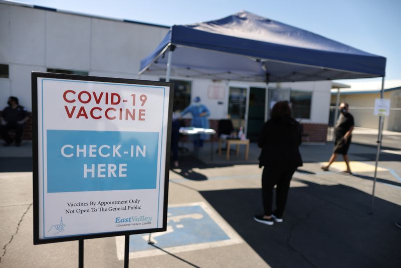 People arrive for coronavirus disease (COVID-19) vaccinations, at East Valley