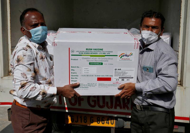 FILE PHOTO: Officials unload boxes containing vials of COVISHIELD vaccine