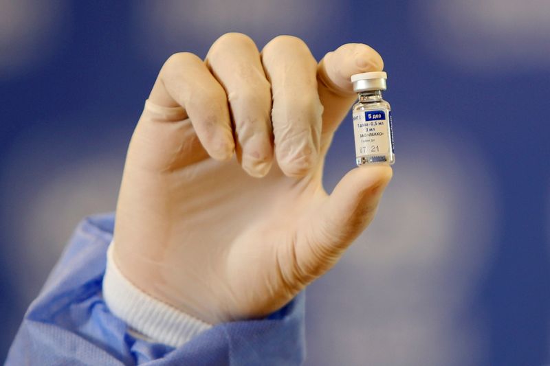 FILE PHOTO: A Palestinian health worker displays a vial of