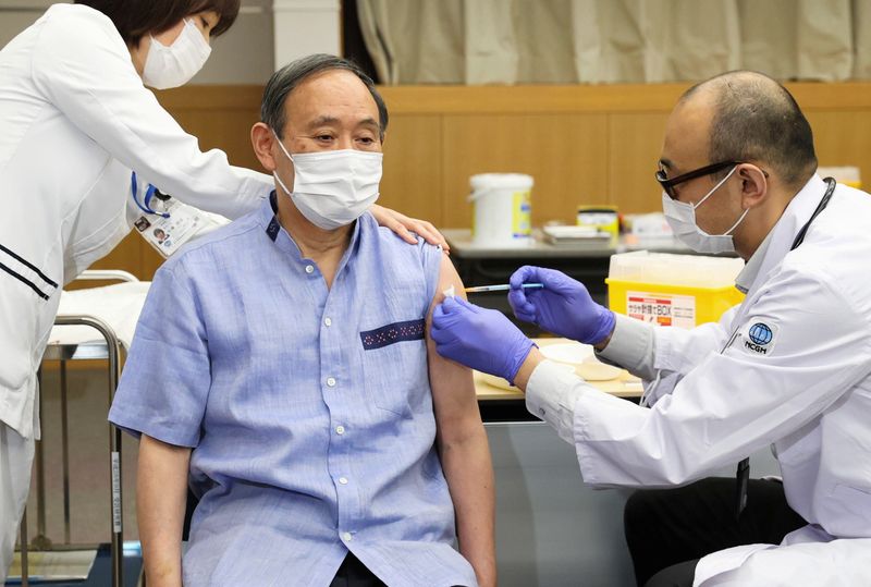 Japan’s Prime Minister Yoshihide Suga receives his first dose of