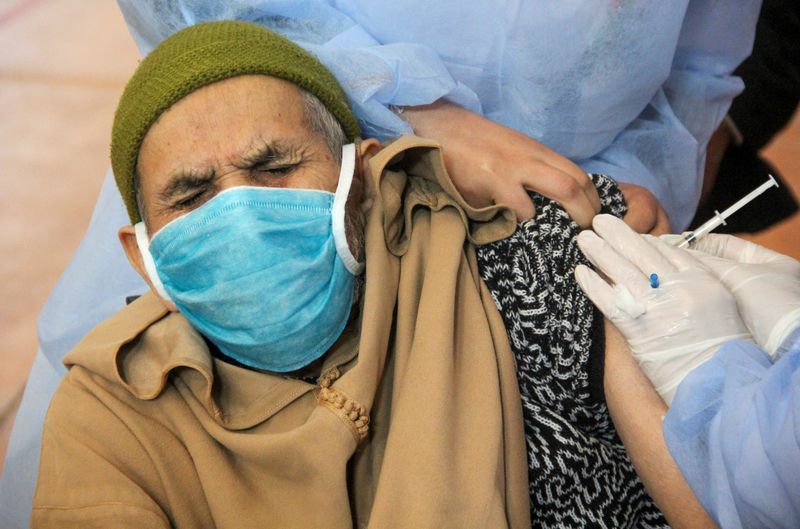 FILE PHOTO: An elderly man receives the COVID-19 vaccine during